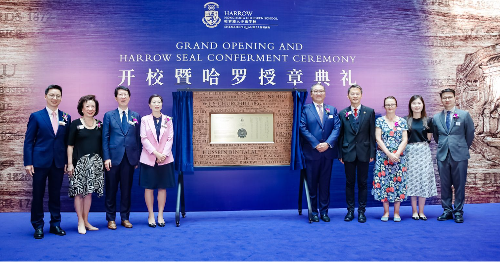 guests pose for a group photo to commemorate the two schools receiving the harrow seal..png